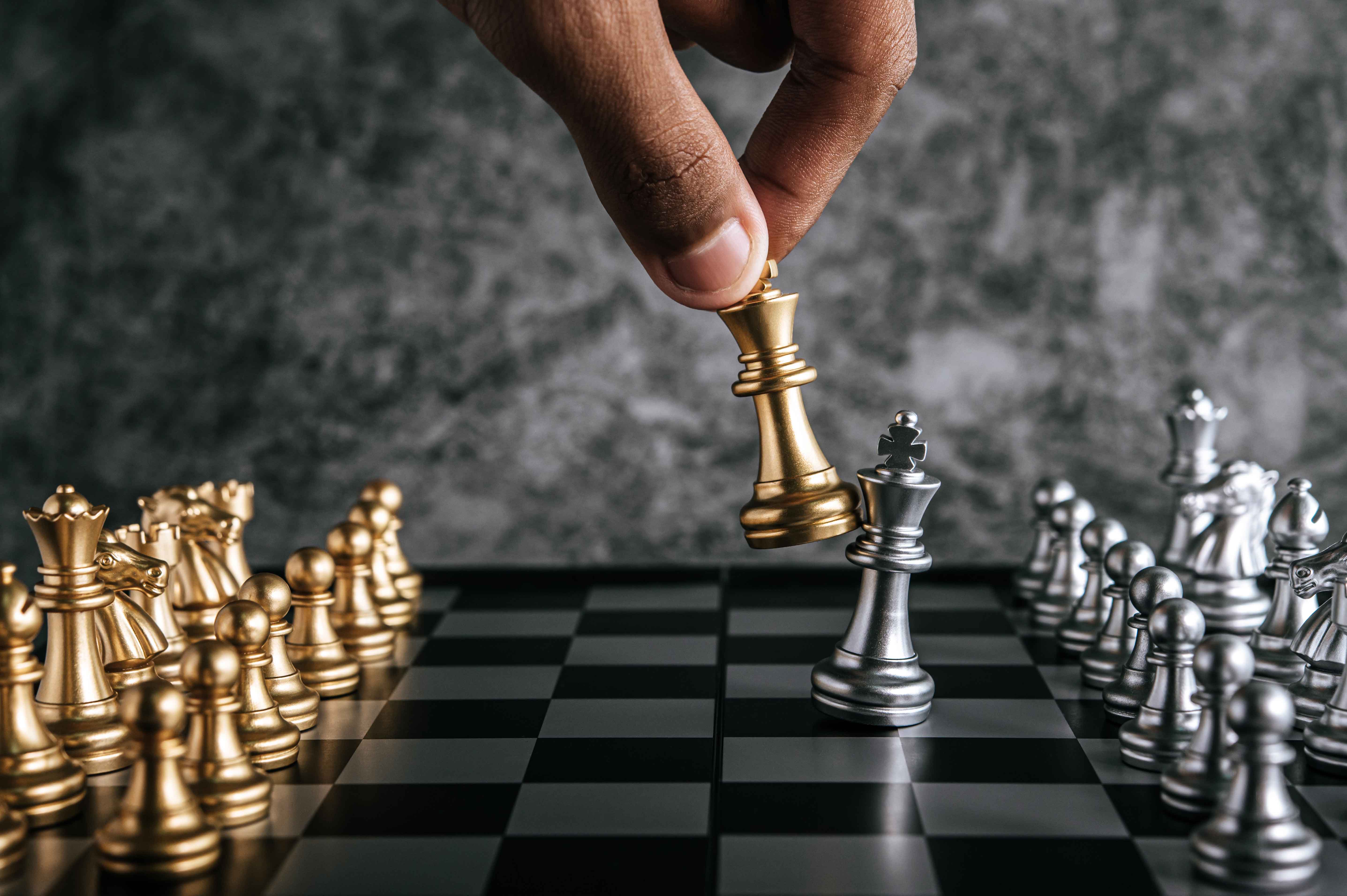 hand-of-man-playing-chess-for-business-planning-and-comparison-of-metaphor-selective-focus.jpg