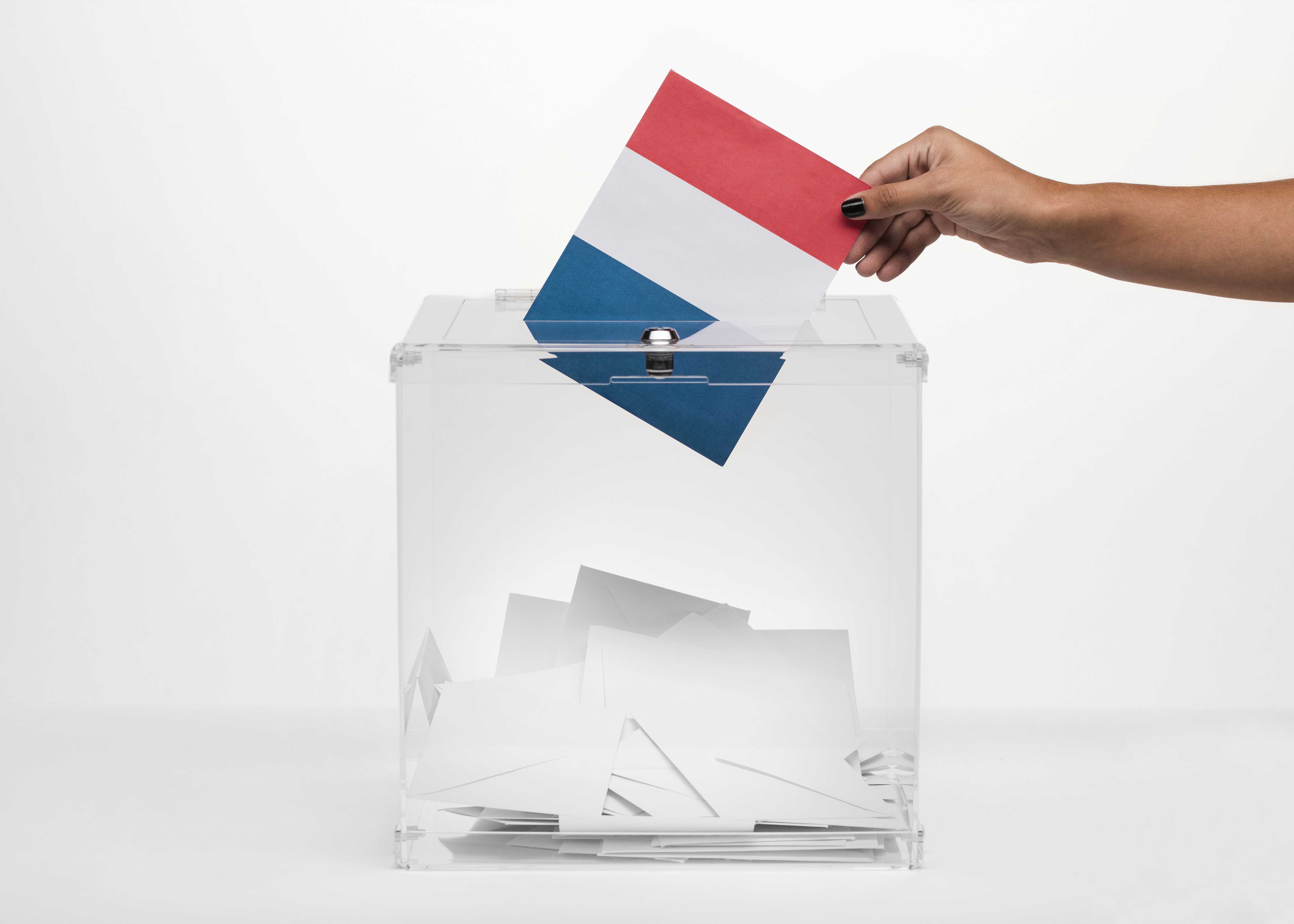 person-putting-france-flag-card-into-ballot-box.jpg