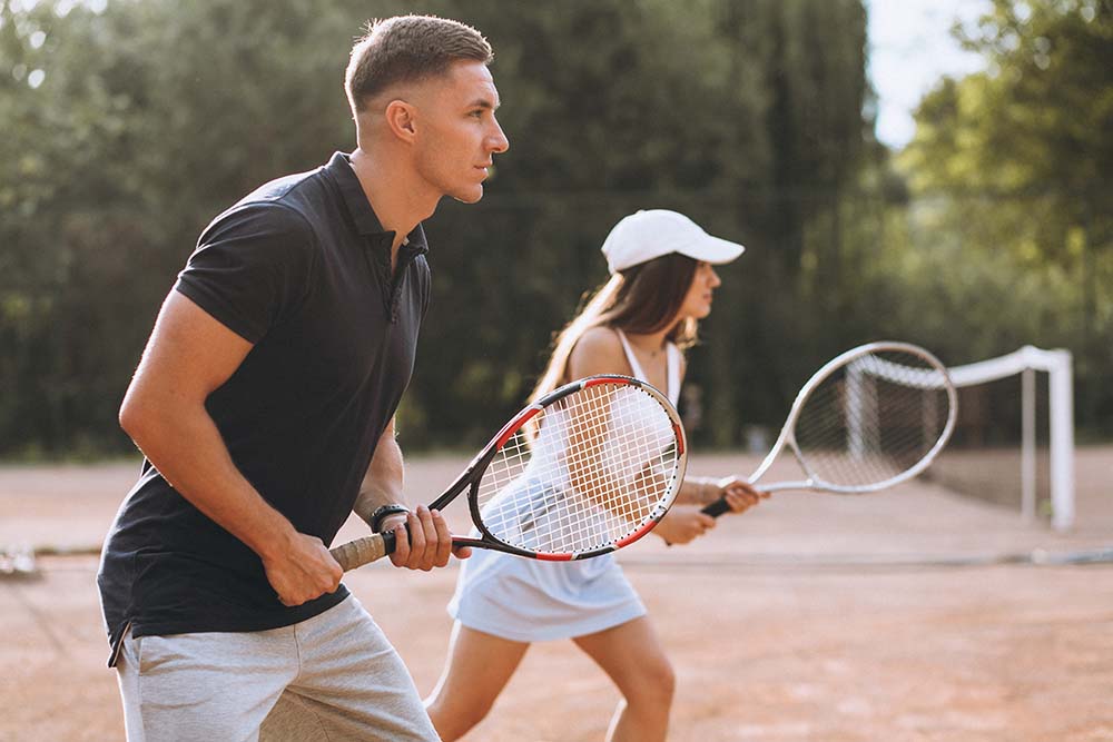 young-couple-playing-tennis-court.jpg