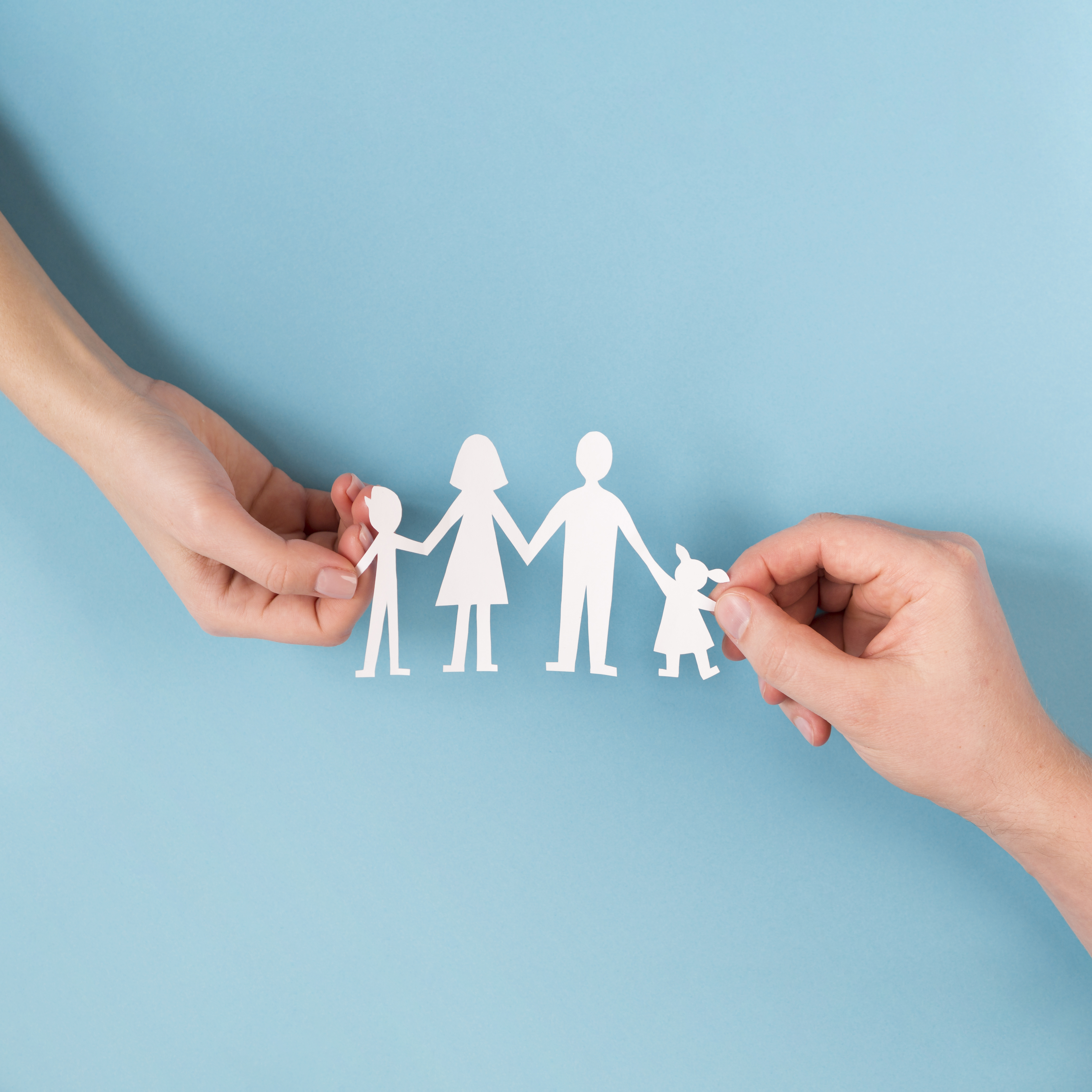 top-view-people-holding-in-hands-cute-paper-family.jpg