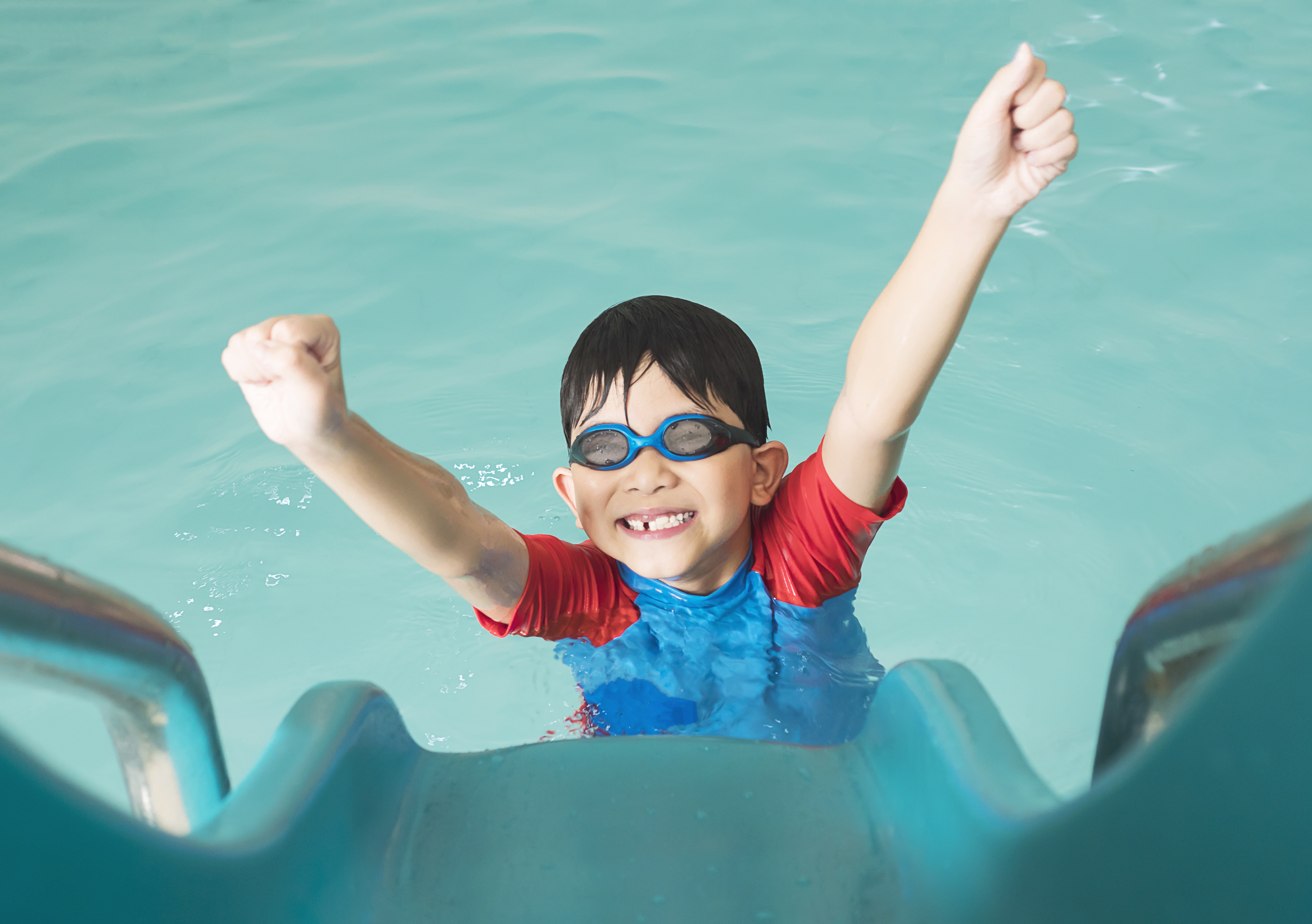 asian-happy-kid-playing-slider-in-swimming-pool.jpg