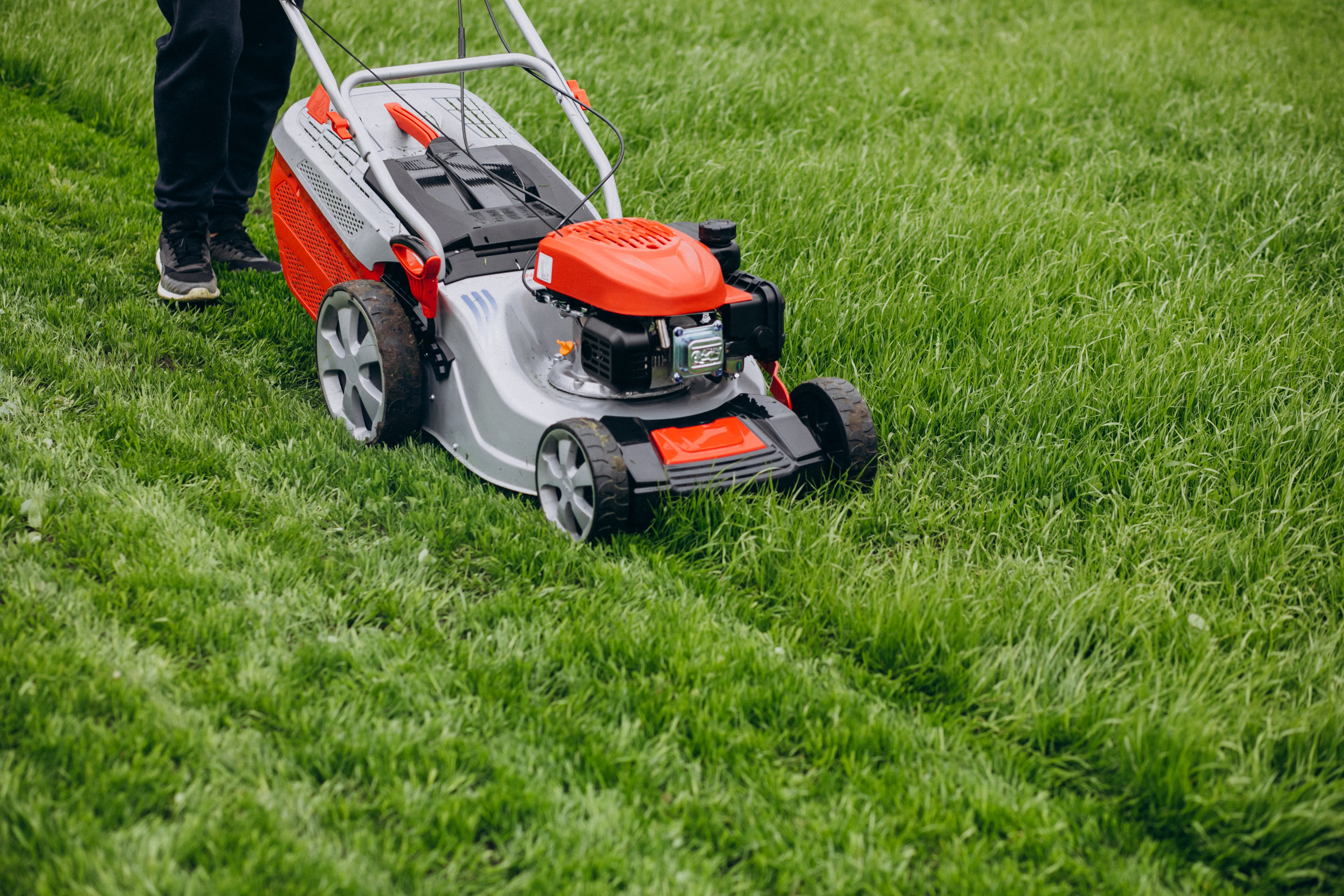 man-cutting-grass-with-lawn-mover-in-the-back-yard.jpg