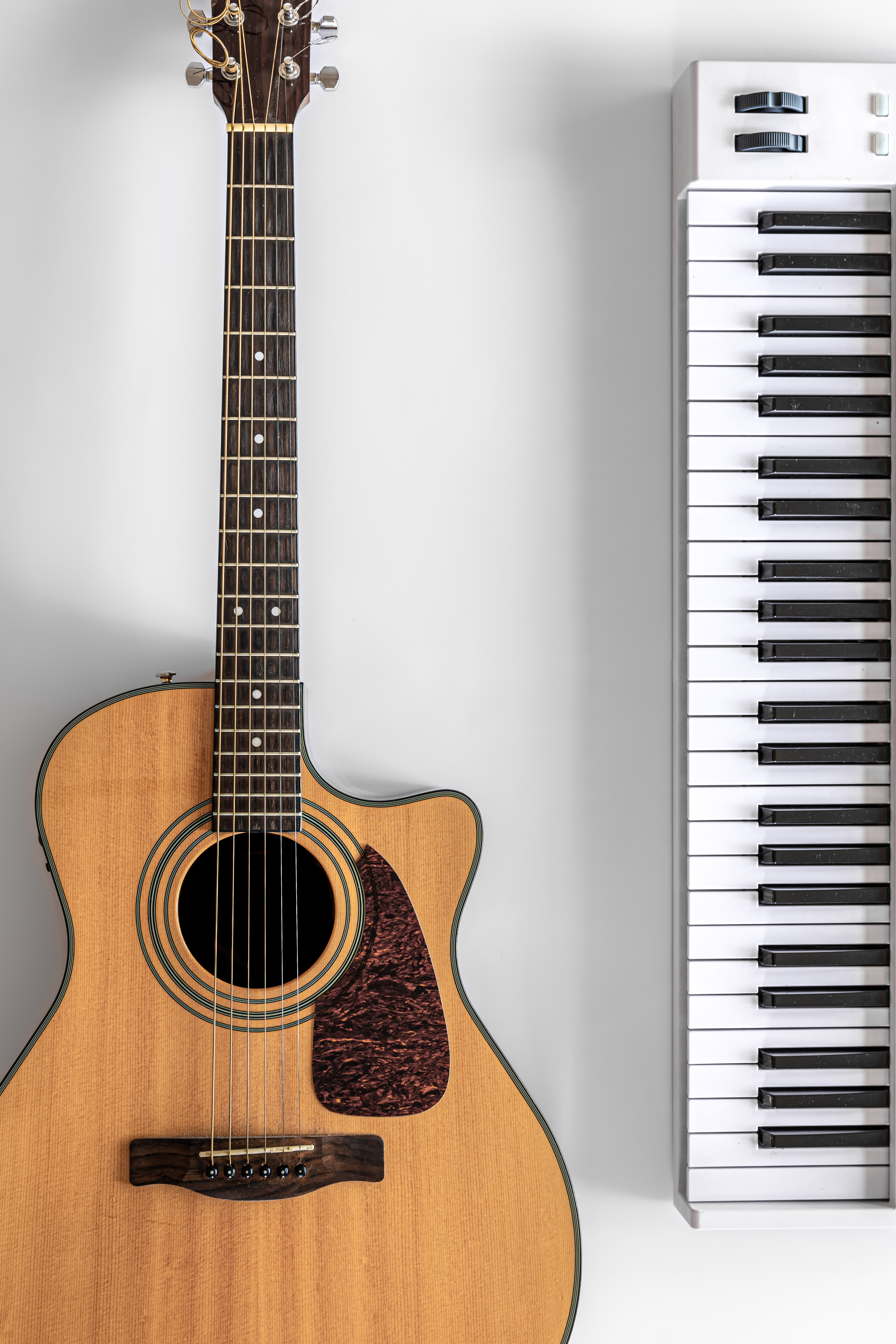 acoustic-guitar-musical-keys-white-background-flat-lay.jpg