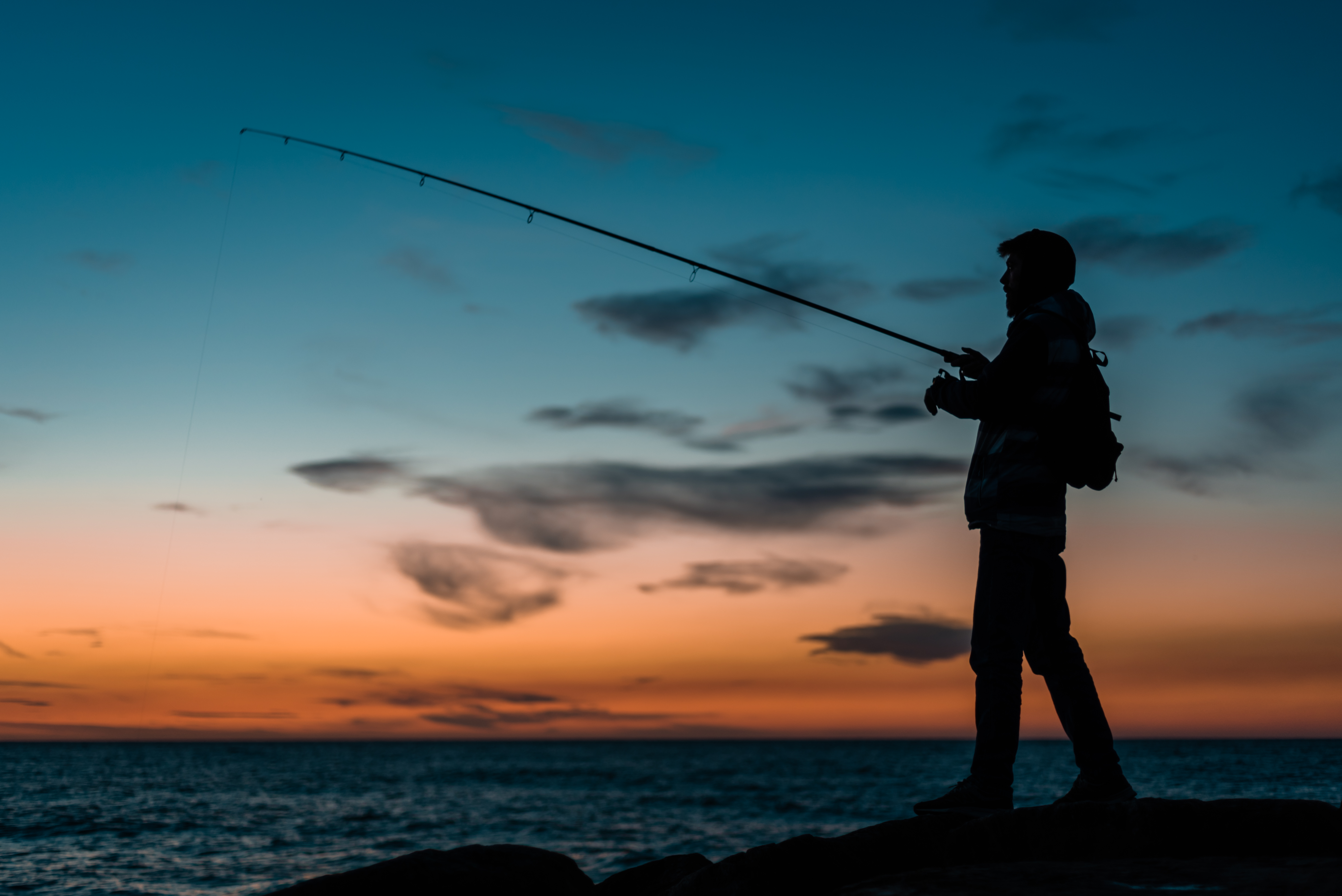 silhouette-man-fishing-beach-sunset.jpg