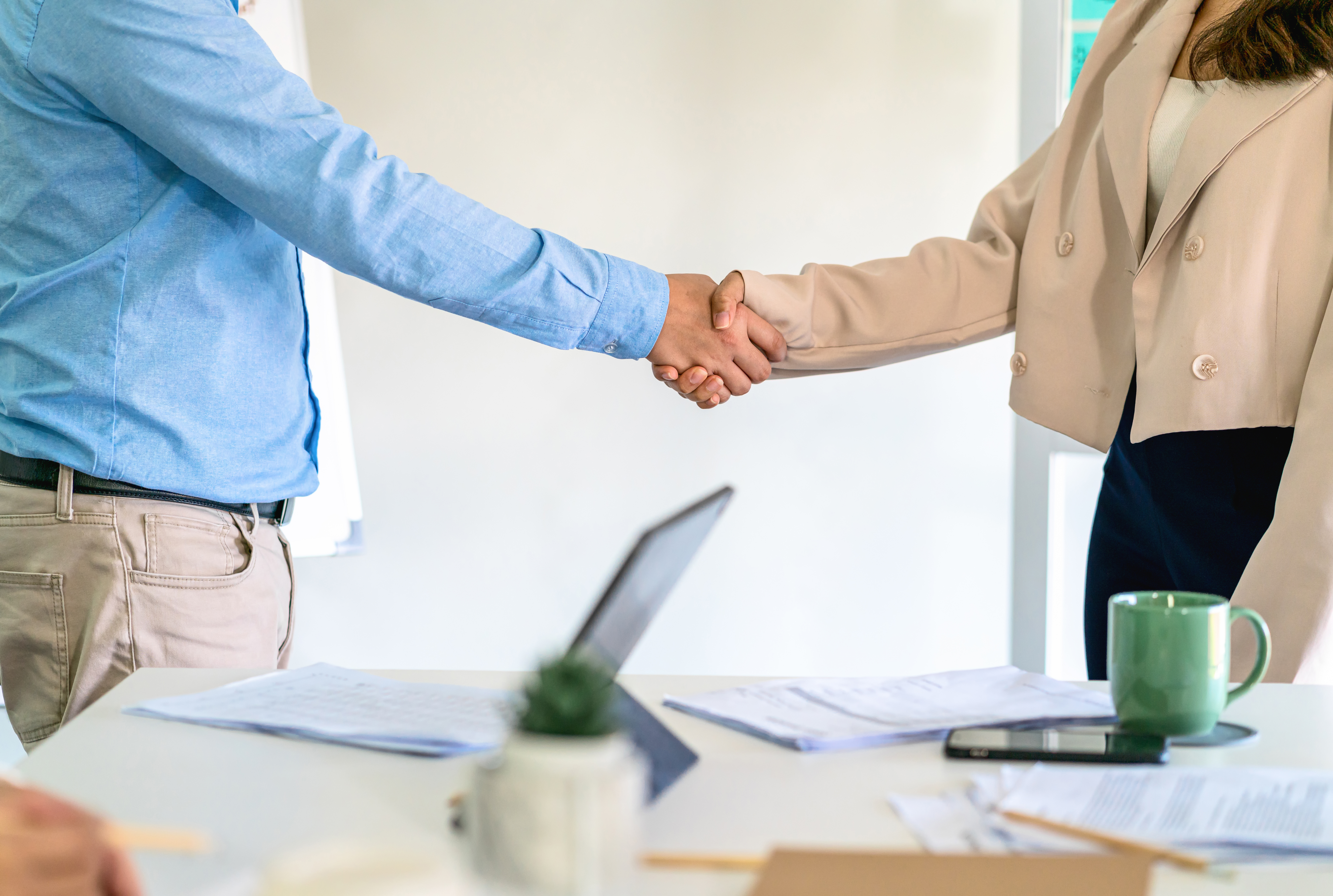midsection-colleagues-shaking-hands-office.jpg